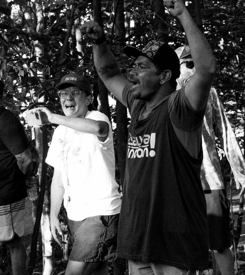 Las Playas don del Pueblo and mourning water protectors and folks who came together to stop deforestation. Man and woman standing and crying.